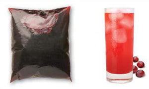 Sachet of Cranberry Juice concentrate next to a tall glass of ice and diluted cranberry juice, surrounded by cranberry fruits.