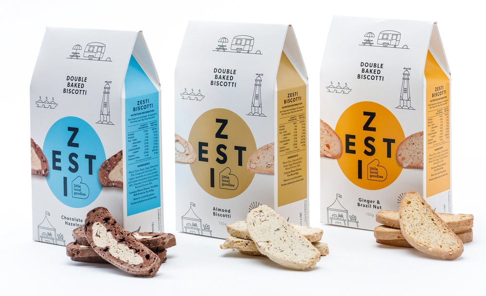 Zesti Double Baked Biscotti, 3 packs with Biscotti biscuits in front.